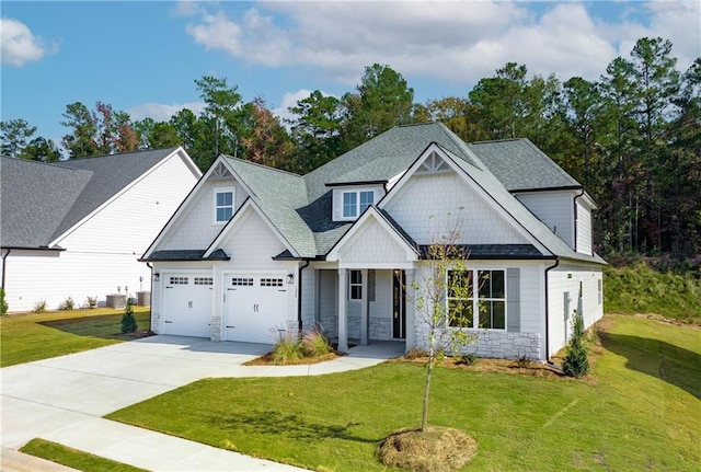 craftsman-style house featuring central air condition unit and a front lawn