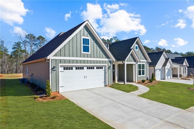 view of front of property featuring a garage, a front lawn, and central air condition unit