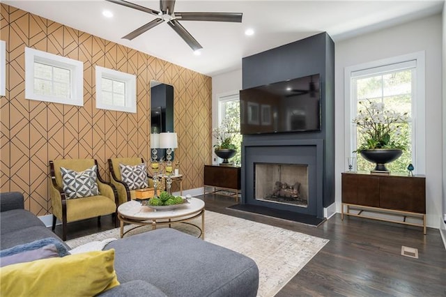 1821 Huntington Hills Ln NW, Atlanta, GA 30309 - living room with an accent wall, ceiling fan, wallpapered walls, a fireplace with flush hearth, and dark wood-type flooring