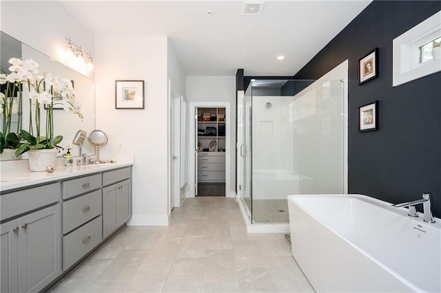 1821 Huntington Hills Ln NW, Atlanta, GA 30309 - full bath with double vanity, a stall shower, a freestanding tub, a walk in closet, and baseboards
