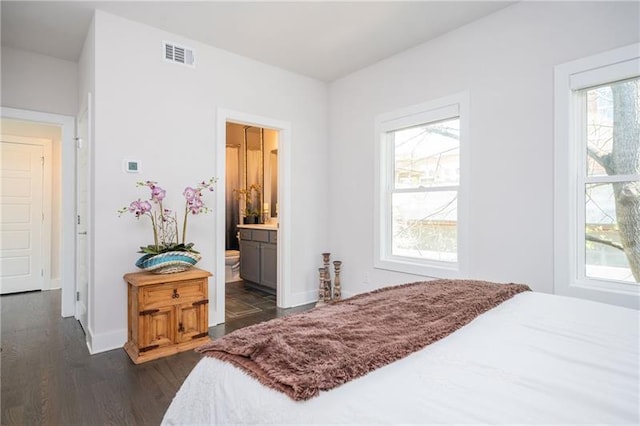 1821 Huntington Hills Ln NW, Atlanta, GA 30309 - bedroom with dark wood-style floors, baseboards, and connected bathroom