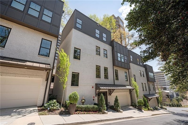 1821 Huntington Hills Ln NW, Atlanta, GA 30309 - multi unit property featuring an attached garage, brick siding, stucco siding, and a standing seam roof