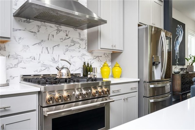 1821 Huntington Hills Ln NW, Atlanta, GA 30309 - kitchen with stainless steel appliances, range hood, tasteful backsplash, and light countertops