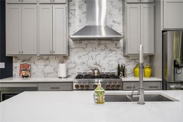 1821 Huntington Hills Ln NW, Atlanta, GA 30309 - kitchen with wall chimney exhaust hood, stainless steel refrigerator with ice dispenser, gray cabinetry, decorative backsplash, and light countertops