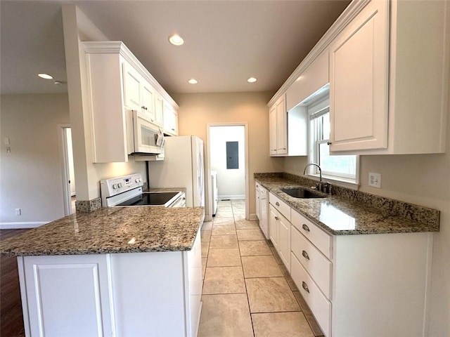 44 Powell Rd NW, Adairsville, GA 30103 - kitchen with white appliances, a sink, white cabinetry, recessed lighting, and dark stone countertops