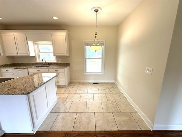 44 Powell Rd NW, Adairsville, GA 30103 - kitchen with a sink, white cabinets, dark stone counters, baseboards, and pendant lighting