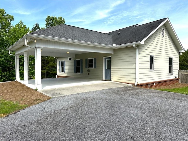44 Powell Rd NW, Adairsville, GA 30103 - view of front of property with a shingled roof, asphalt driveway, a carport, and fence