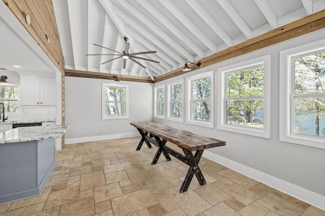dining space featuring stone tile floors, baseboards, and healthy amount of natural light
