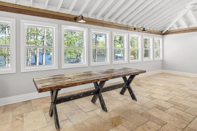 sunroom featuring lofted ceiling