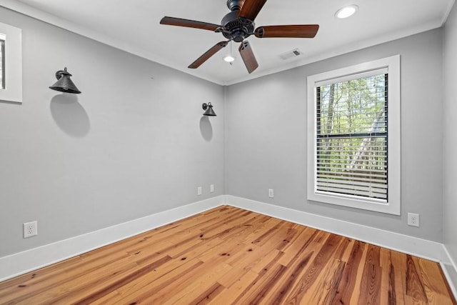 empty room with recessed lighting, a ceiling fan, wood finished floors, and baseboards