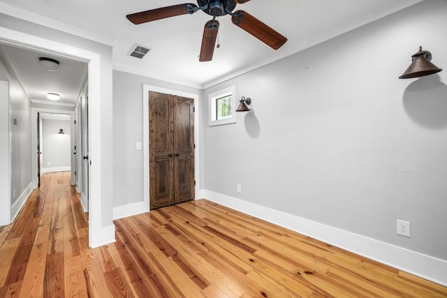 3868 Jack Wilson Rd, Gainesville, GA 30506 - unfurnished bedroom with light wood finished floors, baseboards, a closet, a ceiling fan, and ornamental molding