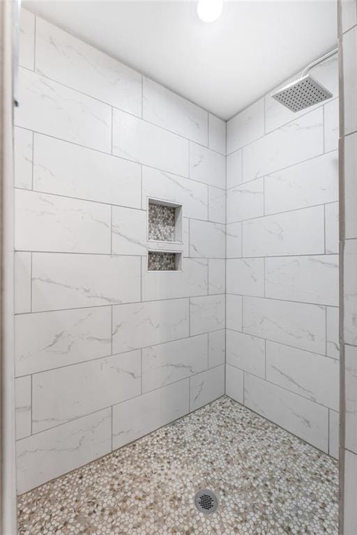 bathroom with a tile shower