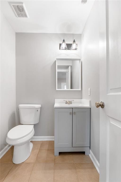 bathroom with vanity, tile patterned floors, and toilet