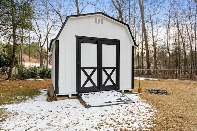 snow covered structure with a yard