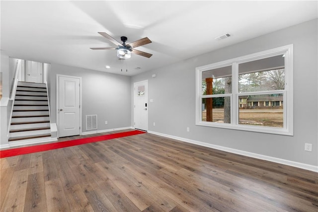 interior space featuring wood-type flooring and ceiling fan