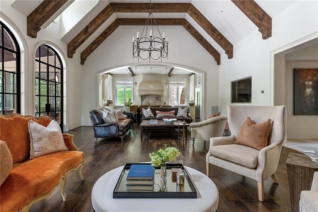 sitting room featuring dark hardwood / wood-style floors, beam ceiling, a fireplace, an inviting chandelier, and high vaulted ceiling