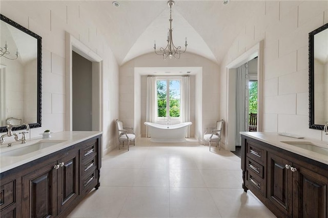 bathroom featuring a notable chandelier, vaulted ceiling, tile flooring, and vanity