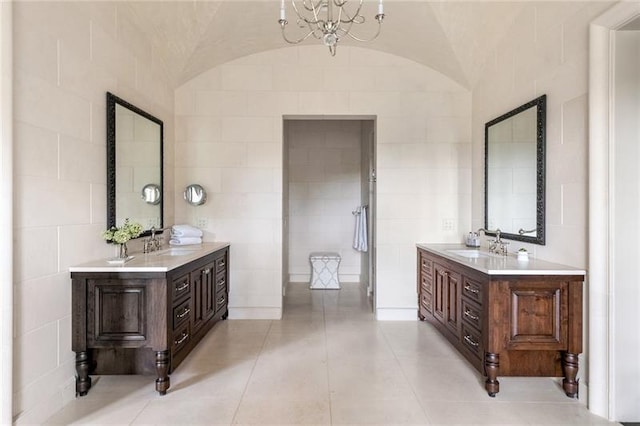 bathroom with tile flooring, double sink vanity, and tile walls