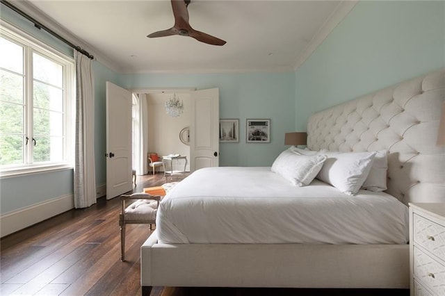 bedroom with crown molding, dark hardwood / wood-style floors, and ceiling fan