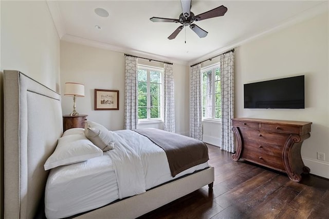 bedroom with ornamental molding, dark hardwood / wood-style floors, and ceiling fan