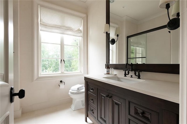 bathroom featuring tile flooring, vanity, and toilet