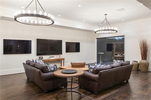 living room with dark hardwood / wood-style flooring, crown molding, and a chandelier