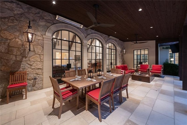 tiled dining room with ceiling fan and wood ceiling