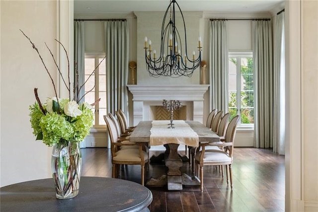 dining area with a notable chandelier, a wealth of natural light, and dark wood-type flooring