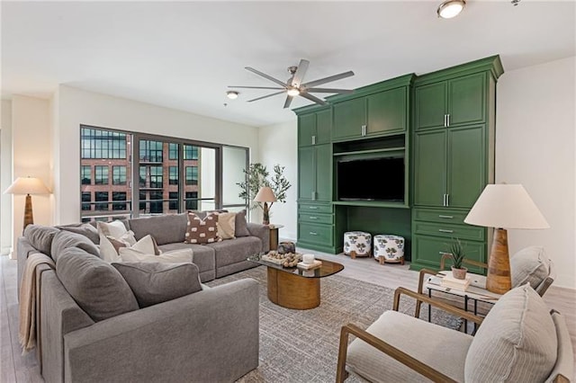 living room with ceiling fan and light hardwood / wood-style floors