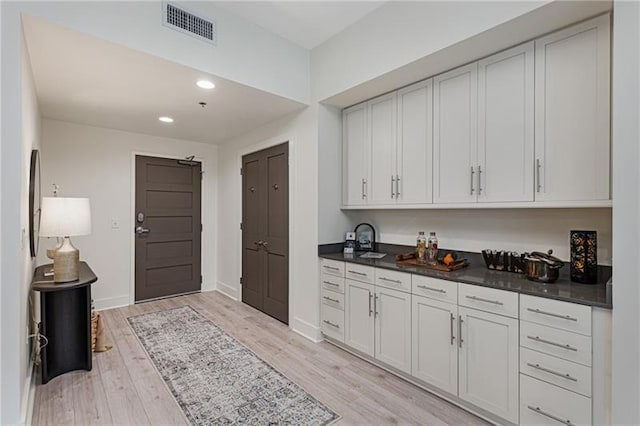 kitchen featuring white cabinetry and light hardwood / wood-style floors