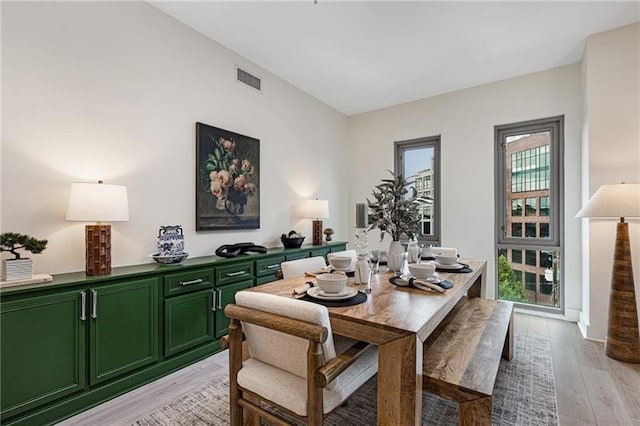 dining space with light hardwood / wood-style floors