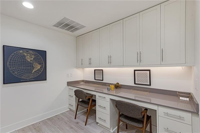 office area featuring built in desk and light hardwood / wood-style floors