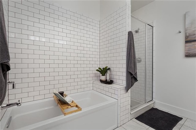 bathroom with shower with separate bathtub and tile patterned flooring