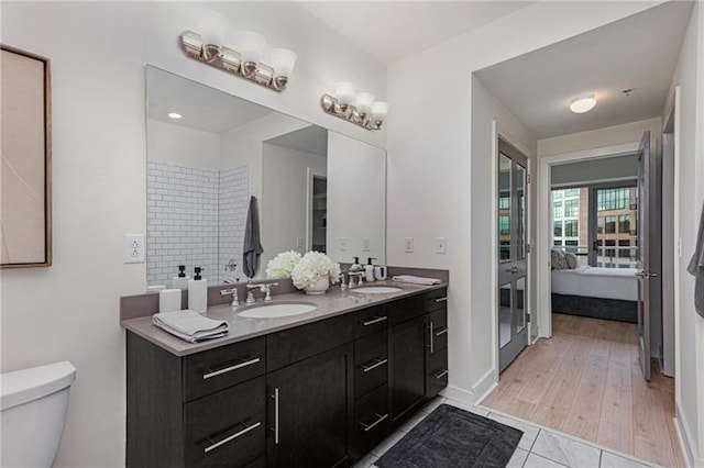 bathroom featuring tile patterned floors, toilet, and vanity