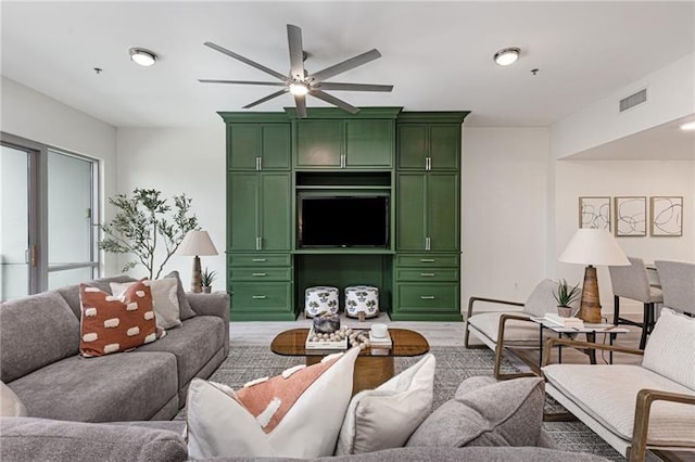 living room with ceiling fan and light wood-type flooring