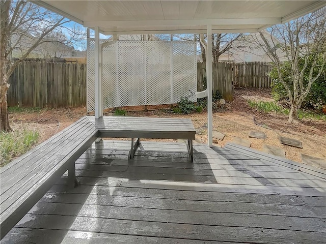 deck with a fenced backyard
