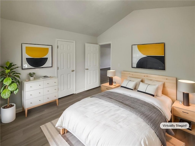 bedroom with lofted ceiling, baseboards, and dark wood-type flooring