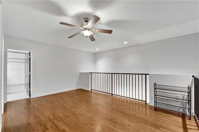 unfurnished room with hardwood / wood-style flooring and ceiling fan