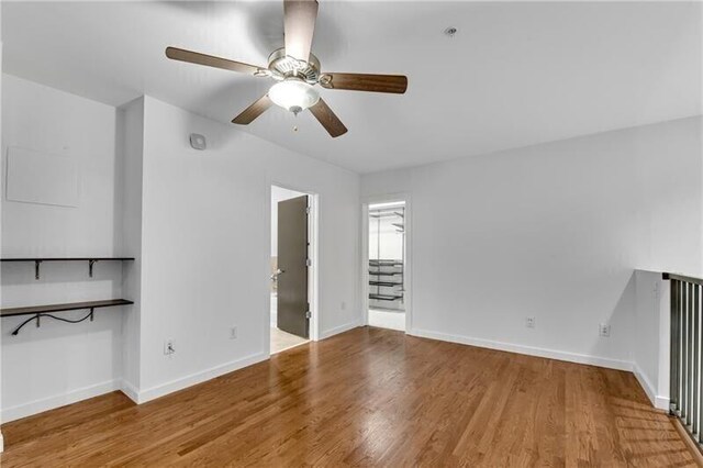 unfurnished living room with hardwood / wood-style flooring and ceiling fan