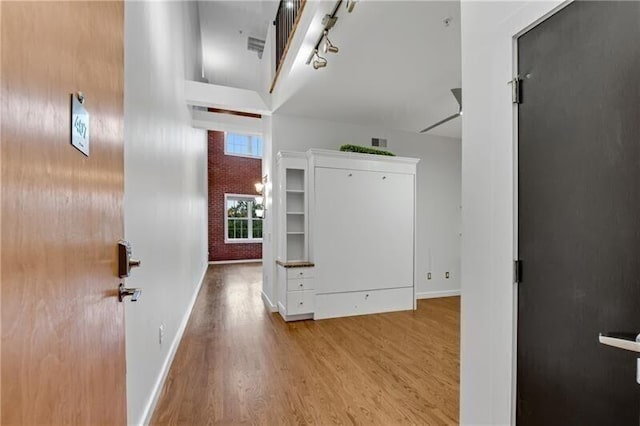 hall with light hardwood / wood-style floors