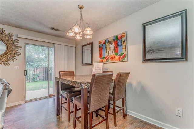 3623 Thurleston Ct SW, Marietta, GA 30008 - dining area with wood finished floors, a chandelier, and a textured ceiling