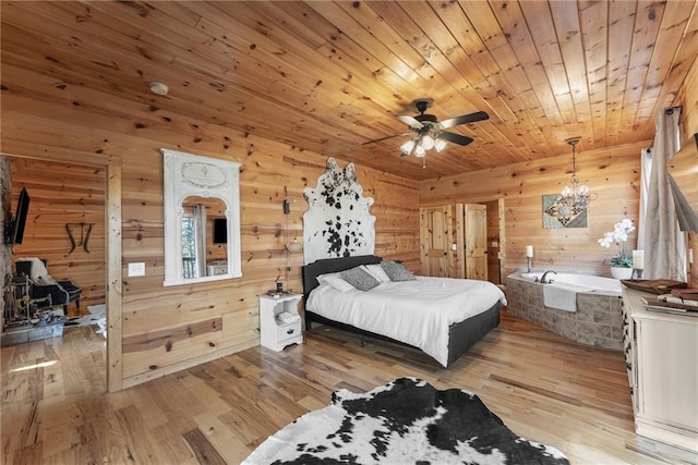 bedroom with light wood finished floors, a notable chandelier, wood walls, and wood ceiling