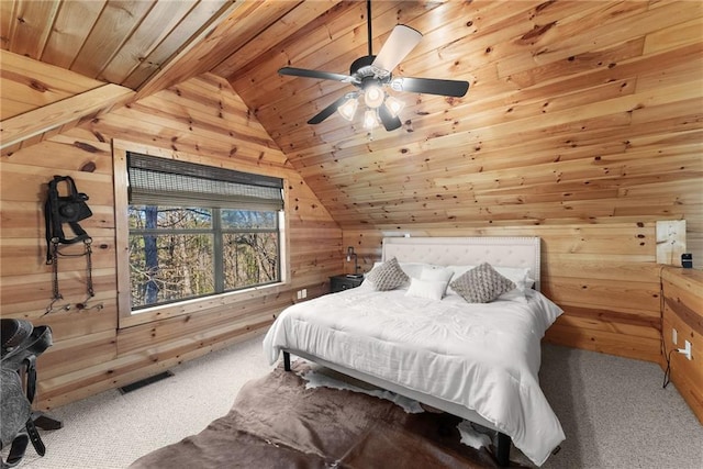 bedroom featuring lofted ceiling, wood ceiling, carpet flooring, visible vents, and wooden walls