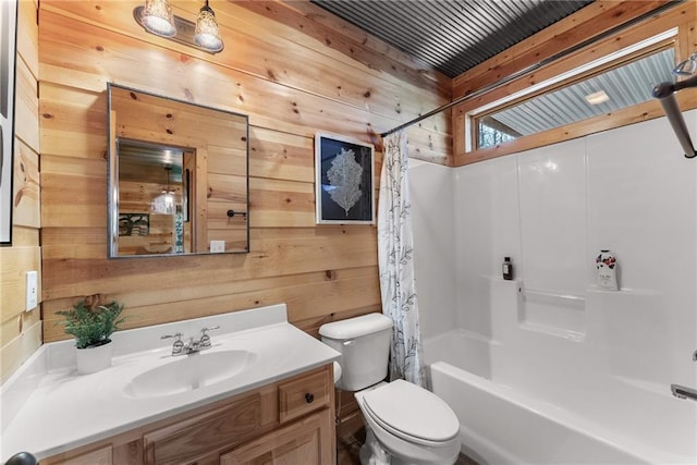 full bathroom with toilet, shower / tub combo with curtain, wooden walls, and vanity
