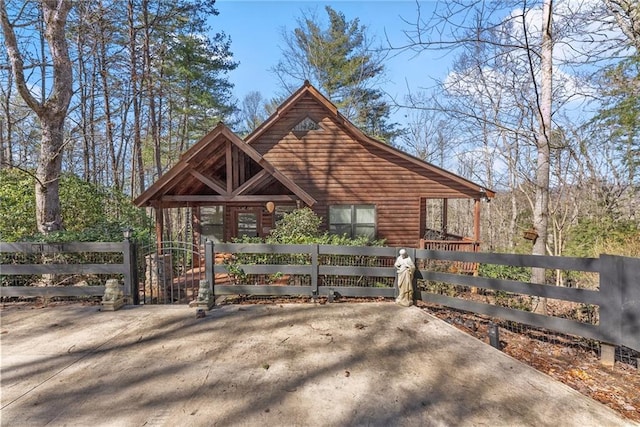 view of outbuilding featuring a fenced front yard and a gate