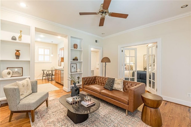 1015 Piedmont Ave NE Unit A2, Atlanta, GA 30309 - living room featuring baseboards, light wood-style floors, visible vents, a ceiling fan, and built in features