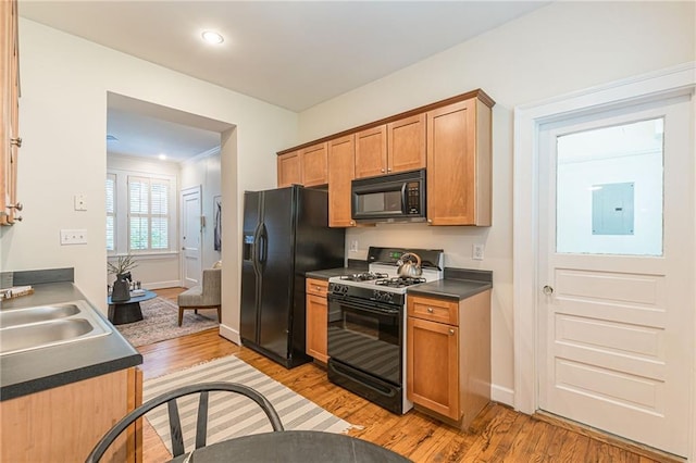 1015 Piedmont Ave NE Unit A2, Atlanta, GA 30309 - kitchen with black appliances, dark countertops, electric panel, and light wood-type flooring