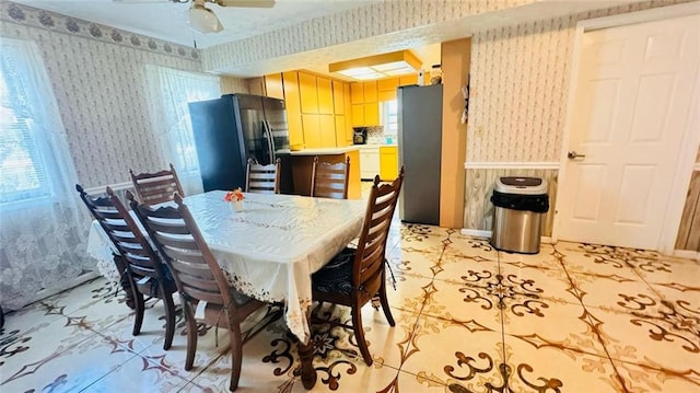 dining space featuring light tile flooring and ceiling fan