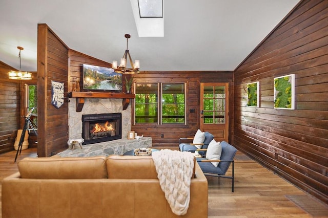 307 Pigeon Creek Rd, Blue Ridge, GA 30513 - living area featuring wood walls, vaulted ceiling, a chandelier, wood finished floors, and a fireplace