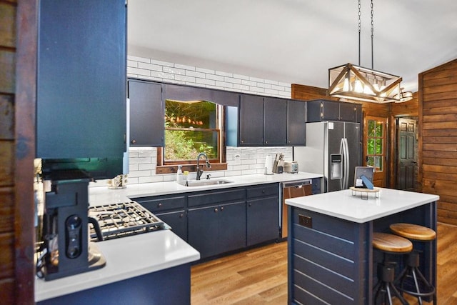 307 Pigeon Creek Rd, Blue Ridge, GA 30513 - kitchen with stainless steel appliances, backsplash, light countertops, light wood-type flooring, and decorative light fixtures